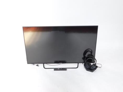 A Sony Bravia 49" flat screen television, serial no 6820628, with remote, and headphones.