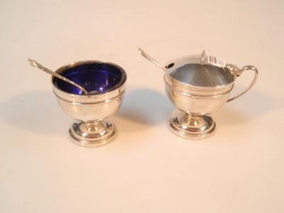 A George V pair of silver pedestal salt and mustard pot