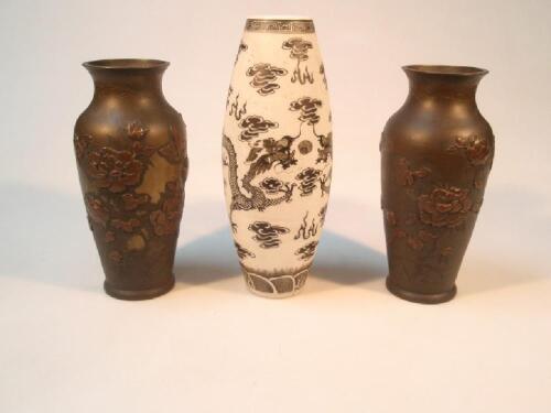 A pair of Japanese bronze baluster vases with applied floral decoration