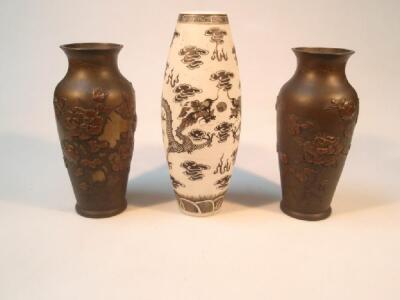 A pair of Japanese bronze baluster vases with applied floral decoration