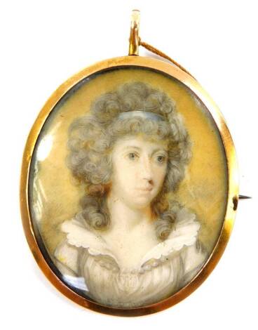 A late 18thC portrait miniature of a lady, in an oval gilt metal pendant mount, with brooch pin attachment, 48mm x 39mm.