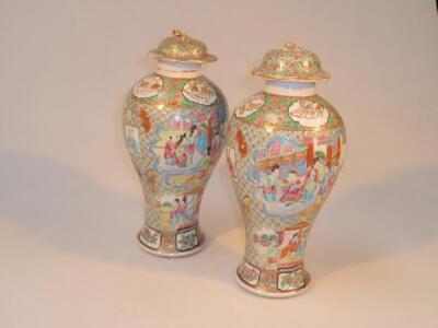 A pair of 19thC Chinese famille rose baluster vases painted with reserves