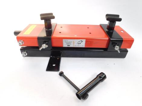 A Black motorcycle scissor jack, maximum 1100lb capacity.