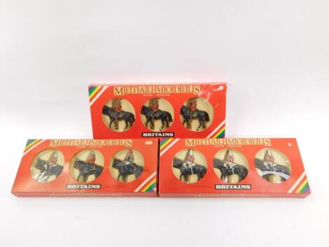 Three Britains Soldiers military boxed sets, comprising three Royal Canadian Mounted Police 7236, Her Majesty Queen Elizabeth Mounted Lifeguard 7233, and three mounted Lifeguards 7228.