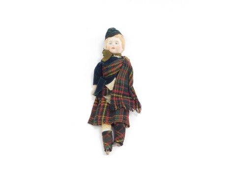 A Victorian bisque porcelain doll, modelled in Highland Dress, 26.5cm H.