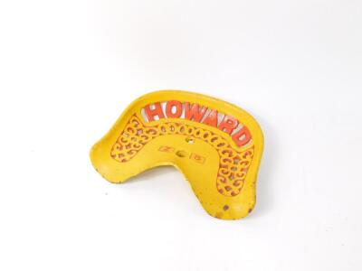 A Howard Z8 cast iron tractor seat, painted yellow with red pierced lettering.