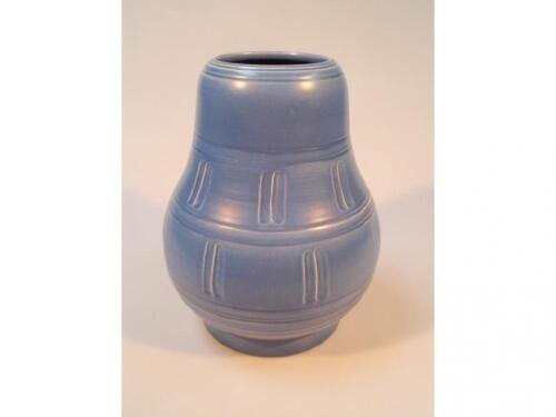 A Susie Cooper studio pottery vase of baluster form within encircling reeded