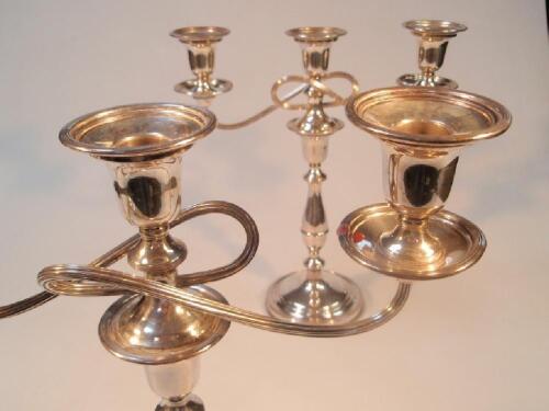 A pair of silver plate three light candelabra