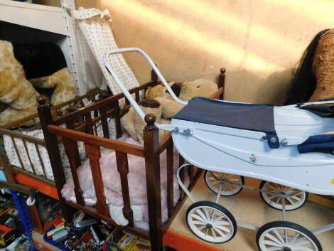 A doll's pram, two oak cots, and a Teddy Bear. (4)