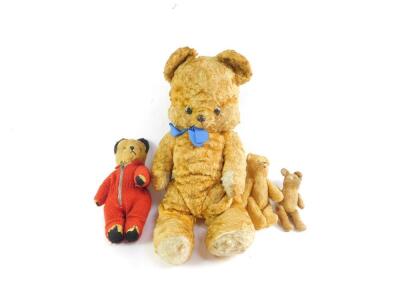 An early 20thC small jointed teddy bear, 14cm H, two further teddy bears, and a Care Bear, 46cm H. (4)