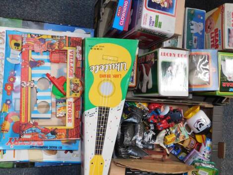 Toys and games, including a Magic Roundabout pastry set, Lark brand ukulele, shape sorter game, battery operated Teddy the drummer bear, and a Tumble battery operated police car, some boxed. (qty)