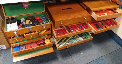 A significant collection of Meccano, in four bespoke chests and boxes, together with Meccano magazine and sundry printed ephemera. (qty)