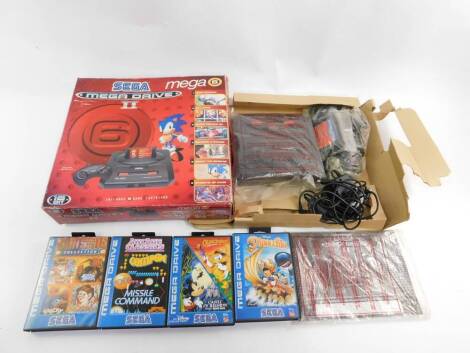 A Sega Mega Drive II, including a six game cartridge, boxed, together with four further games. (5)