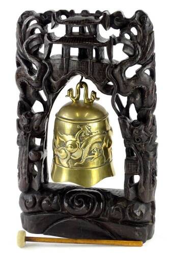 A Chinese bronze gong, cast with dragons, etc., and an elaborately carved hardwood stand, 43cm H overall.