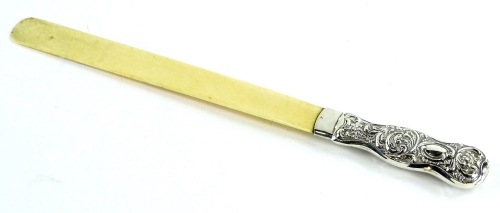 A late Victorian bone and silver mounted page turner, the handle embossed with scrolls, leaves etc., Birmingham 1898, 32cm L.