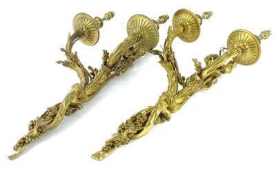 A pair of gilt metal two branch wall lights, each cast with leaves, fruit, bows etc., 60cm H.