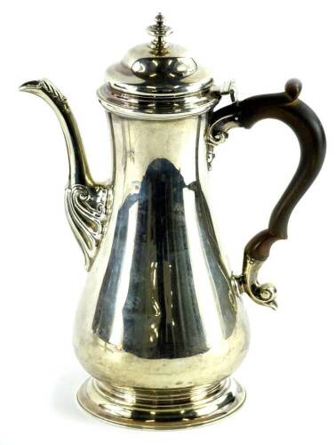 A George VI silver coffee pot, with composite handle, in early 18thC style, with scroll cast spout, tapering foot, London 1942, 24cm H, 20oz.