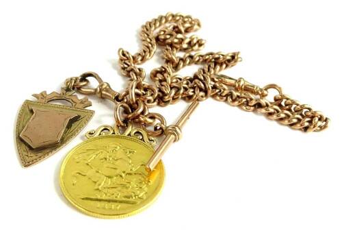 A 9ct gold watch chain with double sovereign and shield fob, the Victorian double sovereign dated 1887, with 9ct gold shield fob with vacant cartouche, on 9ct gold flat curb link chain, with clip and t-bar, 65.4g all in, the chain 41cm long.