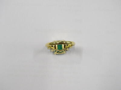 An emerald and diamond ring, with central rectangular cut emerald, in yellow gold claw setting, approx 2.51cts, with round brilliant cut diamond shoulders, three to each side, ring size M, 5.3g all in. - 3