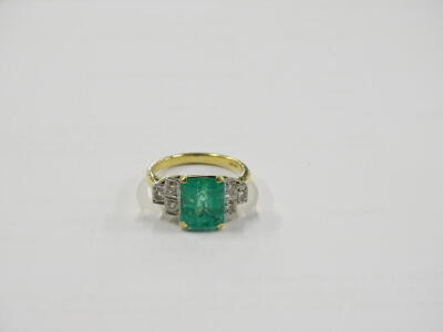 An emerald and diamond ring, with central rectangular cut emerald, in yellow gold claw setting, approx 2.51cts, with round brilliant cut diamond shoulders, three to each side, ring size M, 5.3g all in. - 5