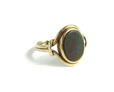 A green and red agate stone set dress ring, of oval design, with twist shaped borders, and two row band (AF-cut), yellow metal unmarked, 3.6g all in.