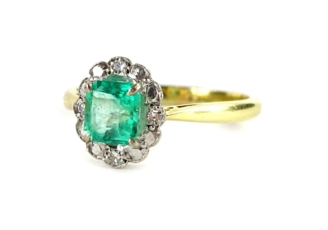 An 18ct gold emerald and diamond cluster ring, with square cut emerald in claw setting, surrounded by design of four tiny diamonds and marcasite stones, ring size Q, 2.6g all in.