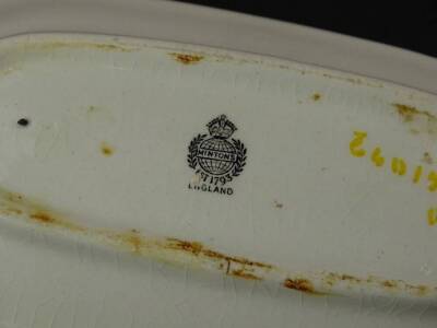 A 1930s pottery part washstand set, decorated with flowers etc., above a puce band. (AF) - 2