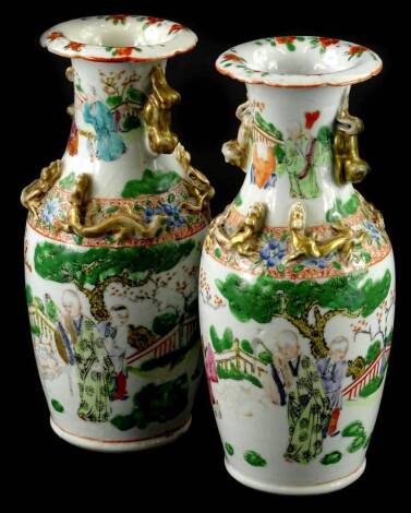 A pair of 19thC Chinese Canton porcelain vases, each decorated in famille verte palette with figures, etc., (AF), 21cm H.