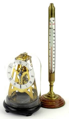 A small brass skeleton timepiece, with silvered dial and glass dome, 18cm H, and a brass desk thermometer. (2)