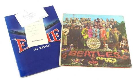 A copy of The Beatles Sgt Pepper's Lonely Hearts Club Band, Queen Night at the Opera, and a theatre programme for Fame The Musical, signed.