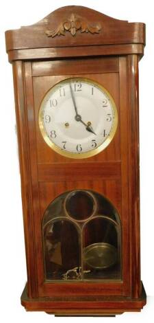 An early to mid 20thC mahogany cased wall clock, the silver coloured dial with Arabic numerals, 77cm H.