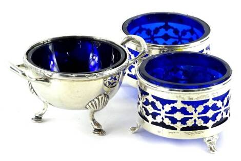 A pair of George V silver salts, each with pierced sides and blue glass liner, Chester 1911 and another salt (3).