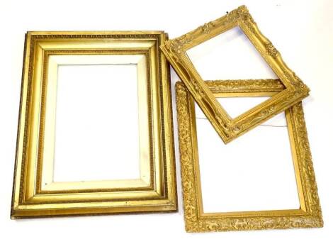 Three gilt gesso rectangular picture frames, each of differing design and size.