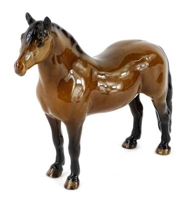 A light coloured brown Beswick pony, with long attached tail.