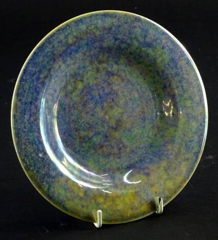 A Ruskin Pottery mottled blue lustre glazed plate, 17.5cm dia.