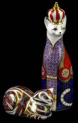 Two Royal Crown Derby porcelain paperweights, a Royal cat, and a seated cat, silver button.