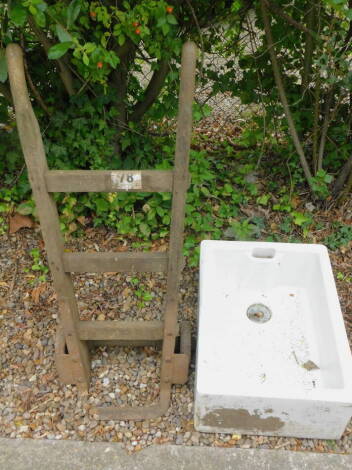 A set of iron and wooden sack barrows (AF) and a Lilco ceramic Belfast sink.