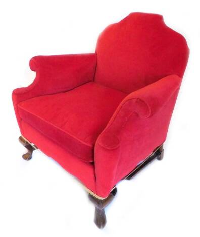 An early 20thC walnut armchair, re upholstered in red velvet on cabriole legs.