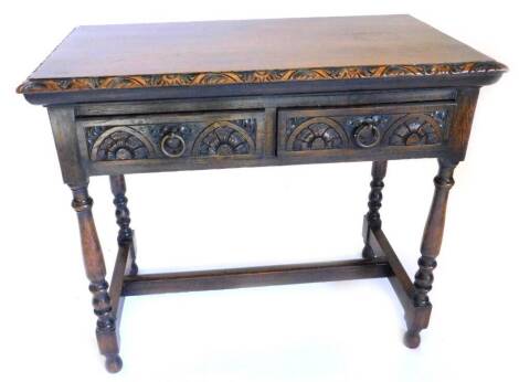 A late 19th/early 20thC carved oak side table, with a moulded edge above two frieze drawers on turned legs with H stretcher, 92cm W.