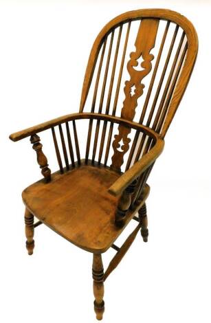 A 19thC ash and elm Windsor chair, with a high back, pierced splat and solid seat on turned legs with H stretcher.