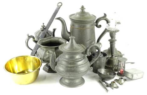 A large quantity of 19thC and later pewter, to include a large hot water jug, a pair of candlesticks, a teapot, hour glass, rectangular box and cover and a small pan or ladle with brass bowl.