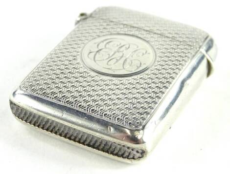 An Edwardian silver Vesta case, with engine turned decoration and monogram to the oval cartouche, Birmingham 1906, made by Henry Charles Freeman, 18.3g.