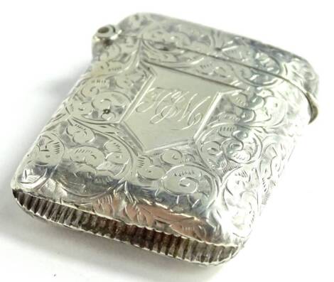 A late Victorian silver Vesta case, engraved with scrolls etc., around a cartouche with monogram, Birmingham 1898 by Constantine and Floyd, 18.1g.