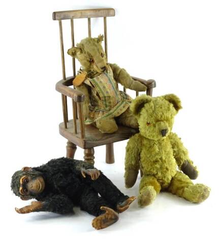 A mid to early 20thC teddy bear, with long limbs, another similar teddy bear, a toy monkey with rubber face etc., and a modern child's stick back Windsor chair.