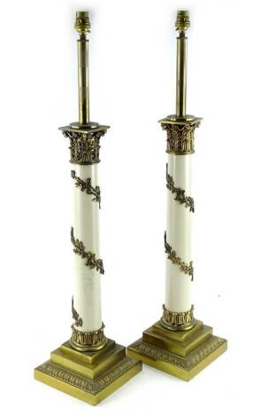 A pair of Stiffel gilt brass table lamps, each modelled in the form of a column with a cream painted central section, decorated with leaves and vines etc., 80cm H.