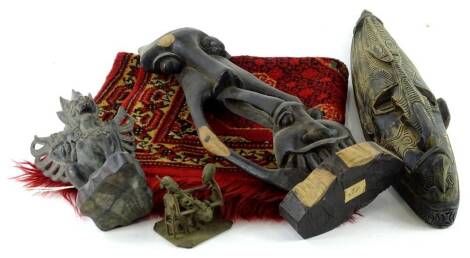 Miscellaneous items, to include a tribal mask, a Balinese type carved dragon, African metal figures etc., small rug, etc.