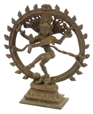 A standing figure of a dancing Indian god, possibly Shiva, with a disc back on stepped base, 20cm H.