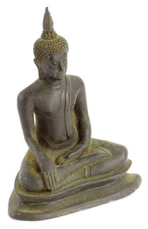 A metal figure of an Indian god, in seated pose, with legs crossed on a stepped inverted base, 20cm H.