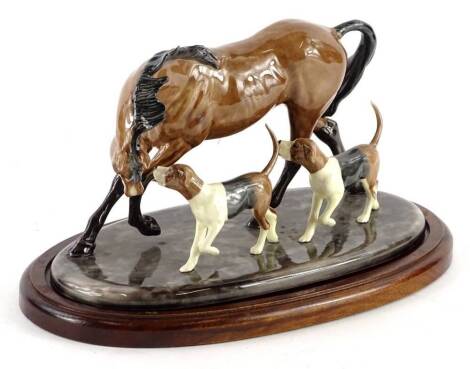 A ceramic figure group, depicting a horse and two hounds, plaque to underside Heredites, on mahogany base, 28cm W.