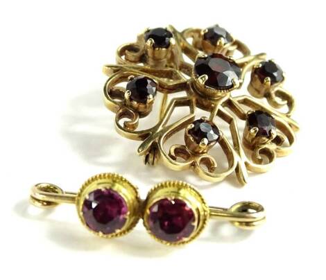 Two brooches, being a 9ct gold circular brooch, set with dark red garnet stones, 3cm W, 5.7g, and a two pale pink stone set brooch, in yellow metal borders, unmarked, 205cm W, 1.6g all in (2).